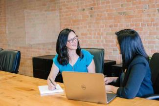 Two women meeting in an office space.